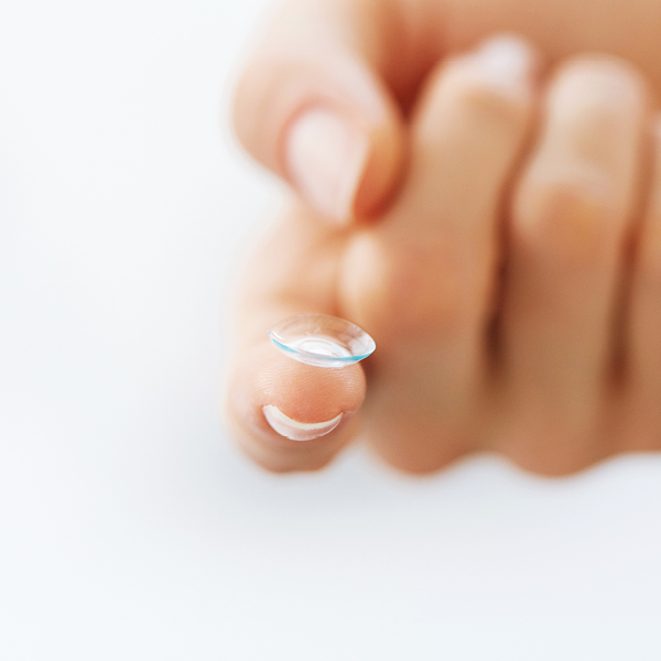 A contact lens resting on a finger.